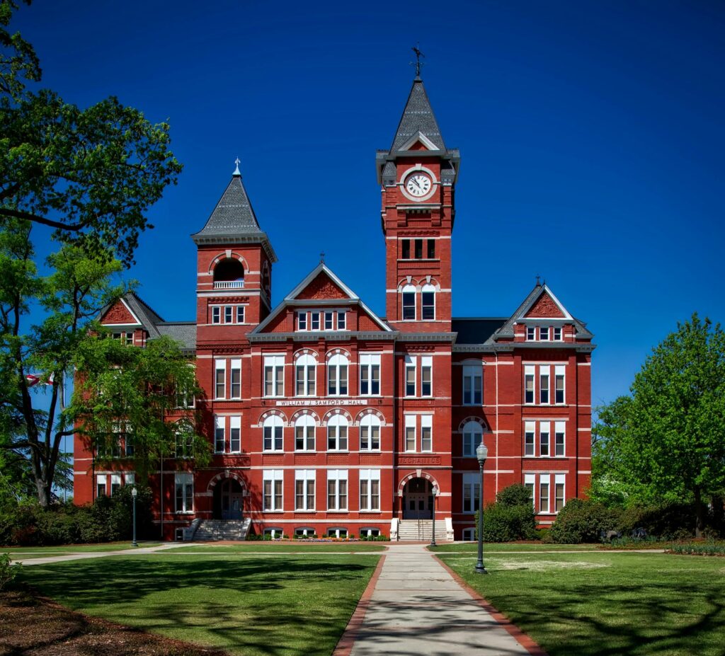 Front view of Samford Hall, Auburn University, with its iconic clock tower on a sunny day.